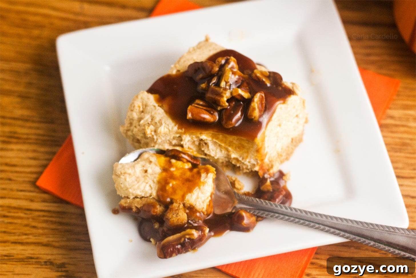 Effortless Pumpkin Cheesecake Squares 7 Spoon cutting into pumpkin cheesecake bars no bake