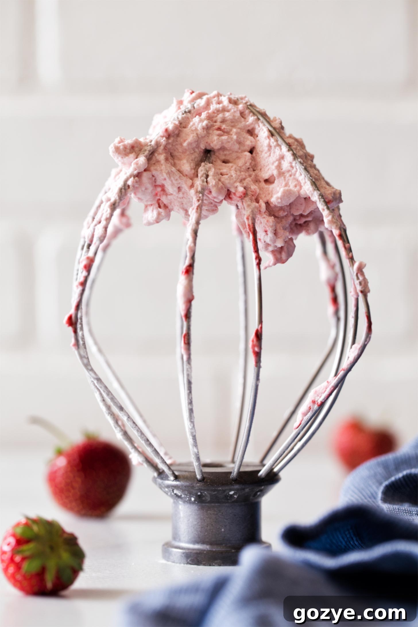Strawberry whipped cream on beater