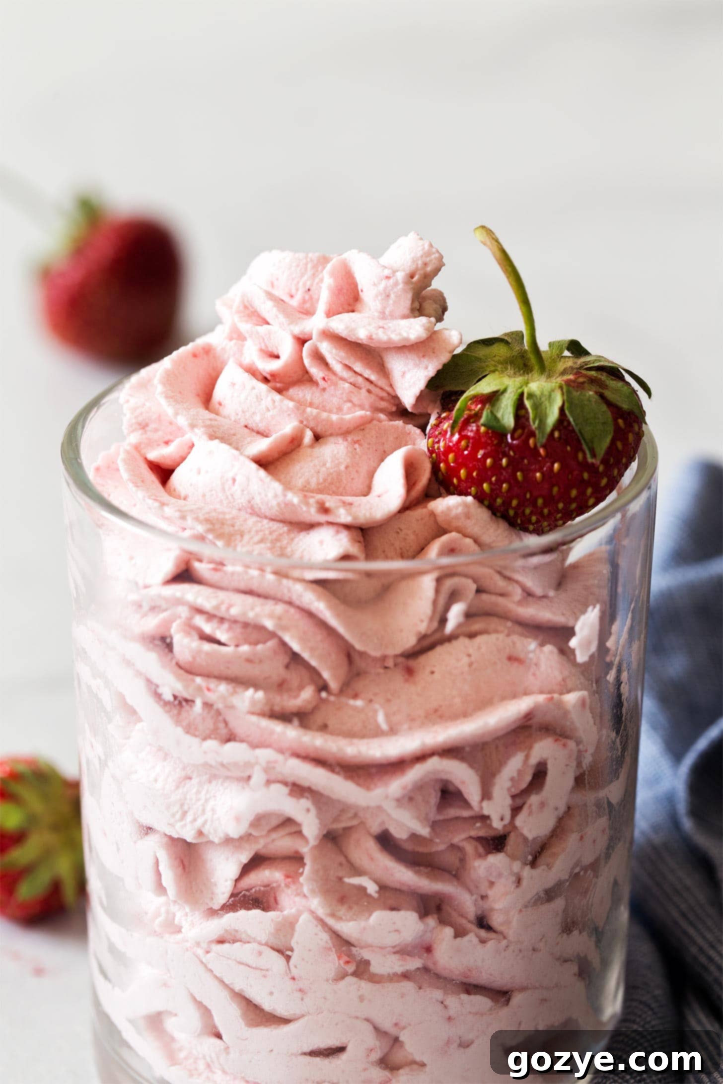 Close up of strawberry whipped cream frosting