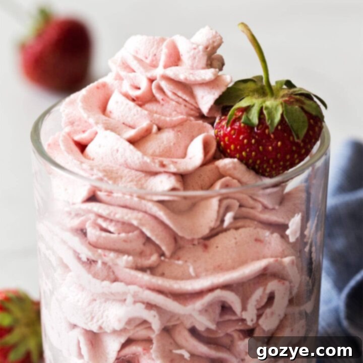 Close up of strawberry whipped cream frosting
