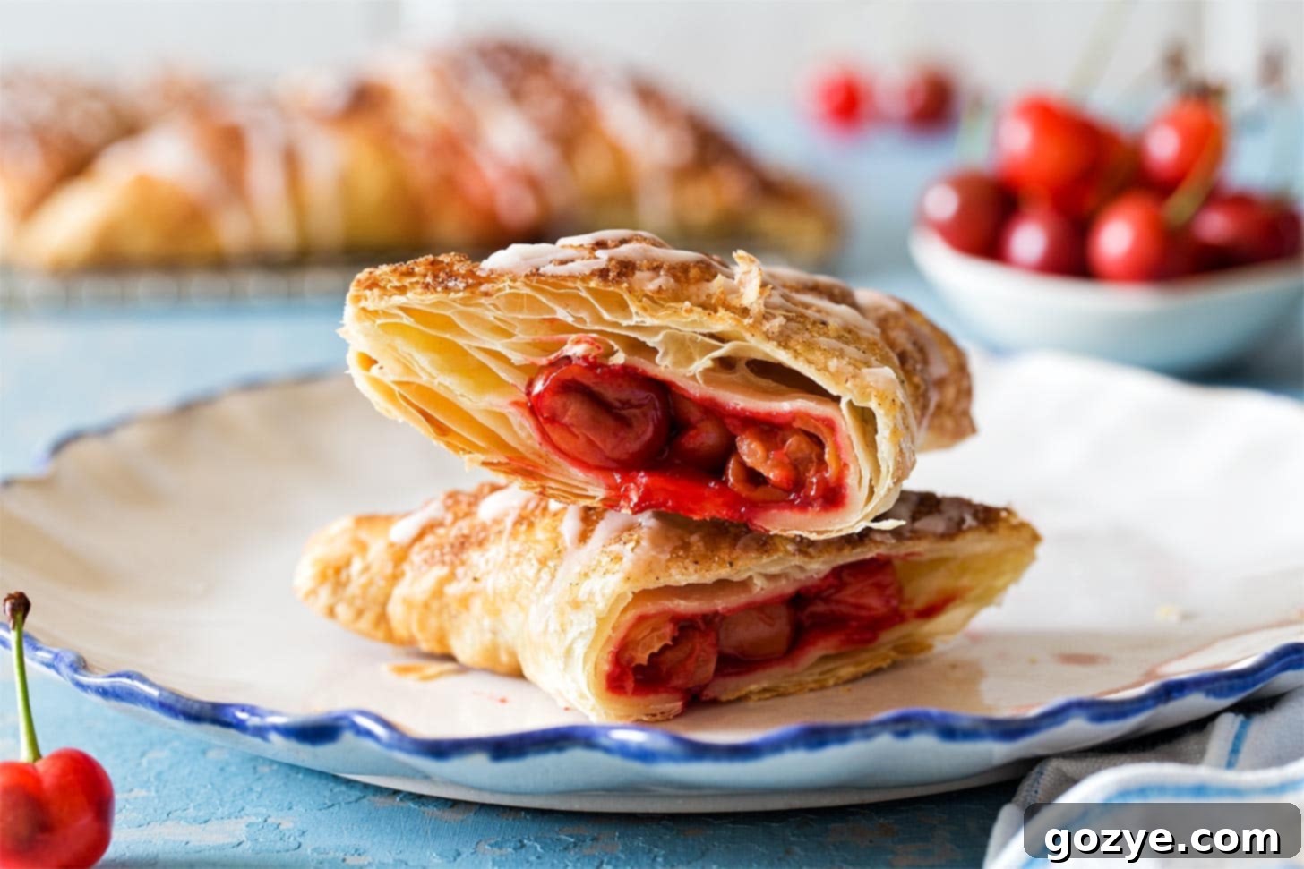 Close-up of baked Puff Pastry Cherry Turnovers with glaze