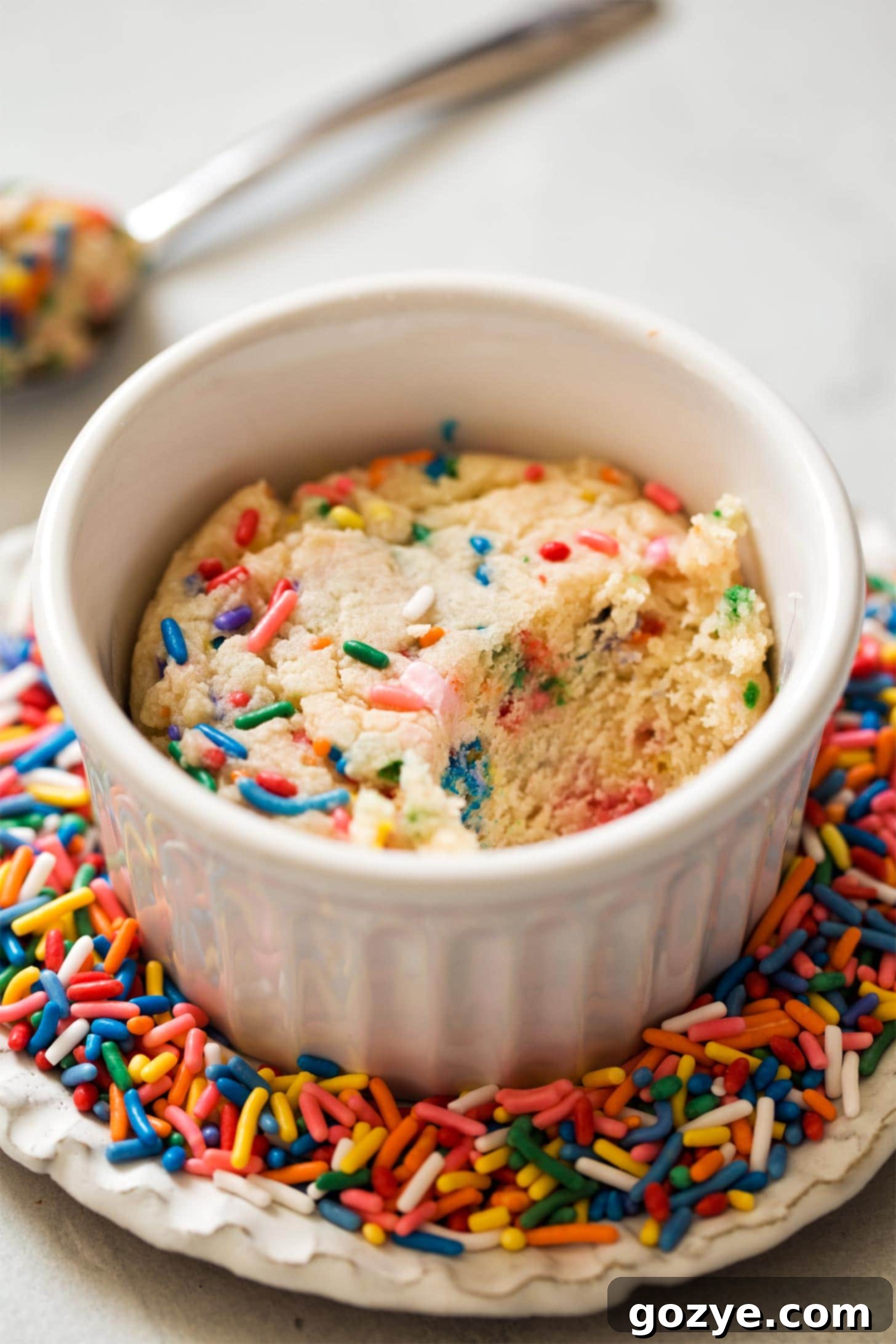 Sugar Cookie in a ramekin on a plate of sprinkles
