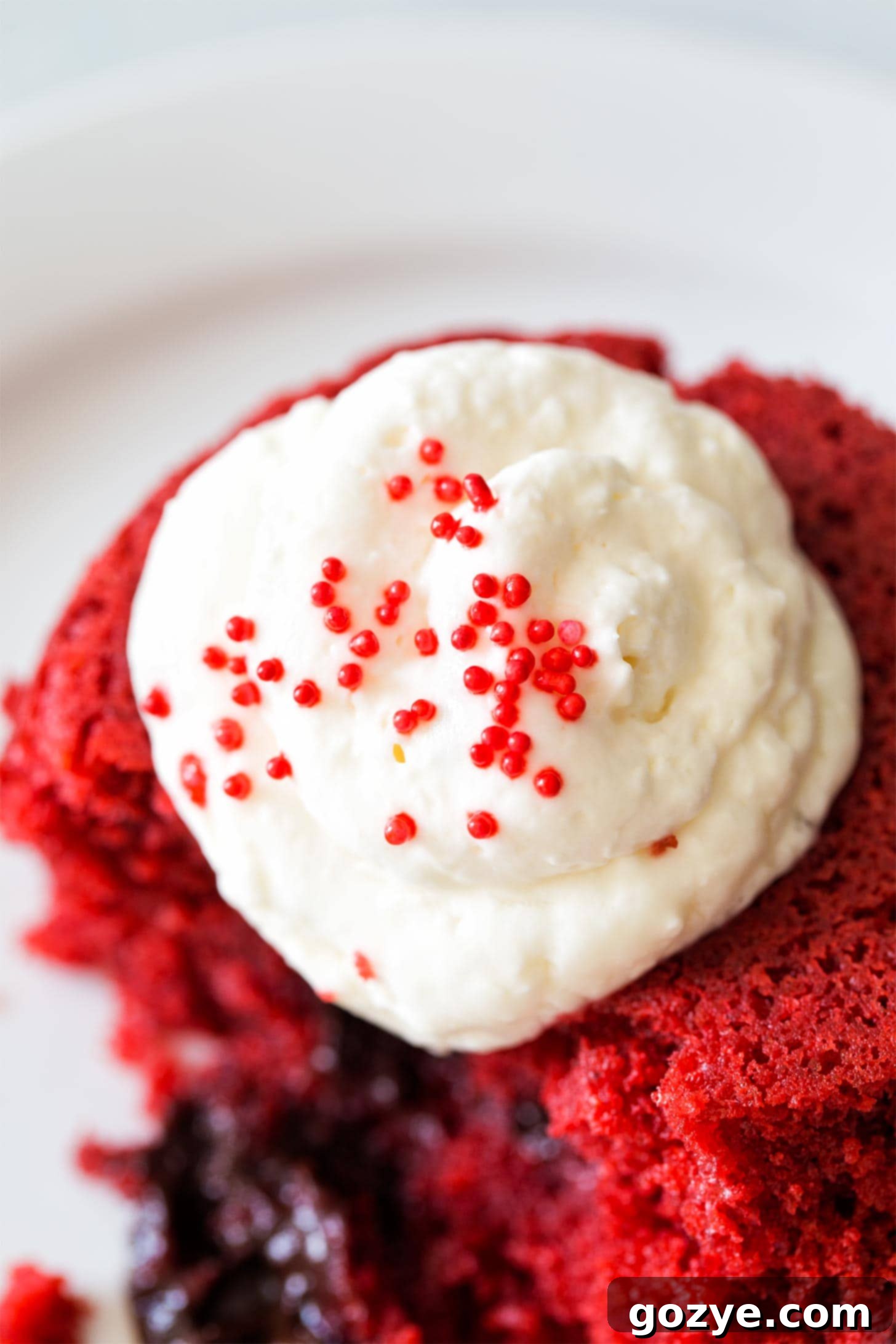 Cream Cheese Whipped Cream on top of red velvet cake