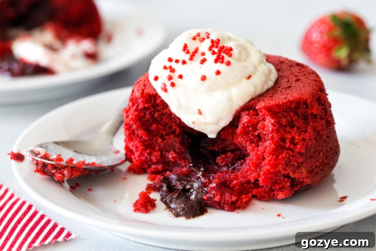 Red Velvet Lava Cakes made in two ramekins on white plate