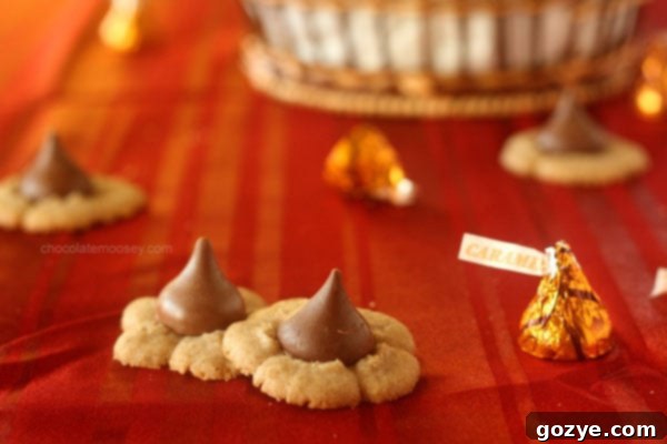 Close-up of a single Caramel Kiss Cinnamon Spritz Cookie showing its intricate pressed shape and the soft caramel center.