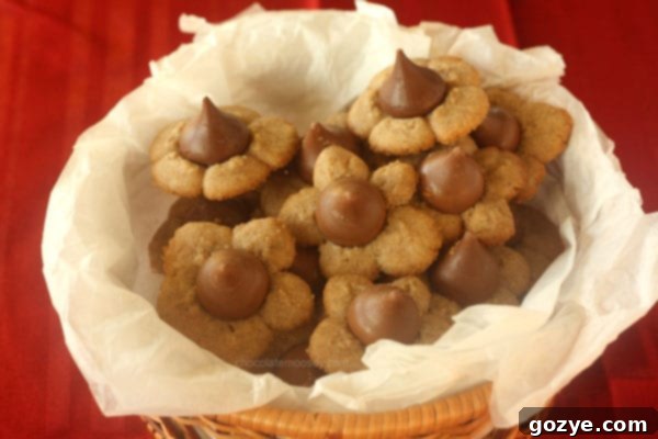 A tray of freshly baked Caramel Kiss Cinnamon Spritz Cookies cooling on a wire rack.