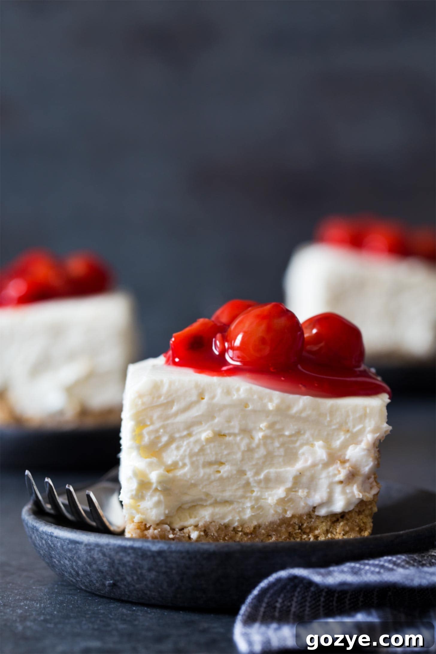 No Bake Cheesecake Bars with cherry pie filling on plates
