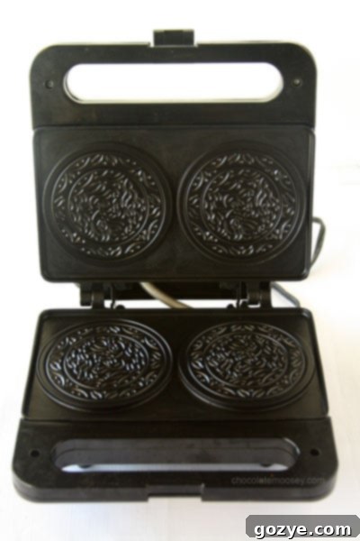 Close-up of Pizzelles batter spreading in the hot iron.