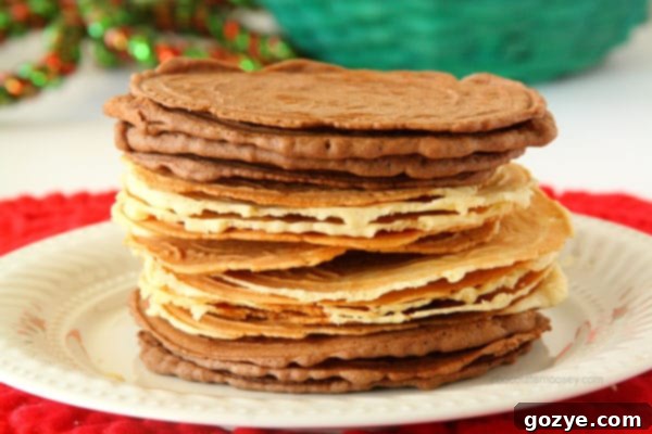 Pizzelles being rolled into a conical shape right after coming off the iron.