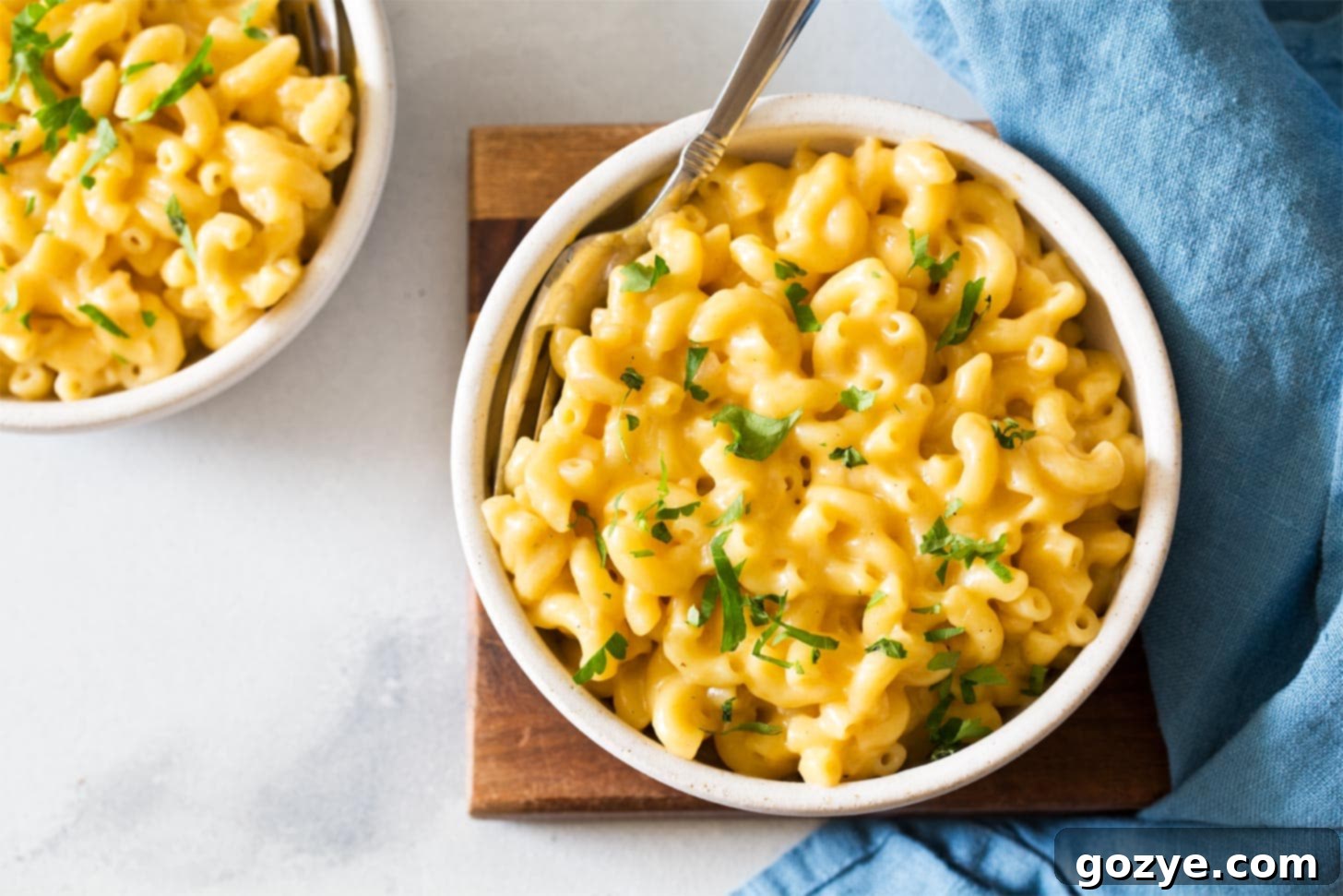 Stovetop mac and cheese in white bowl with fork