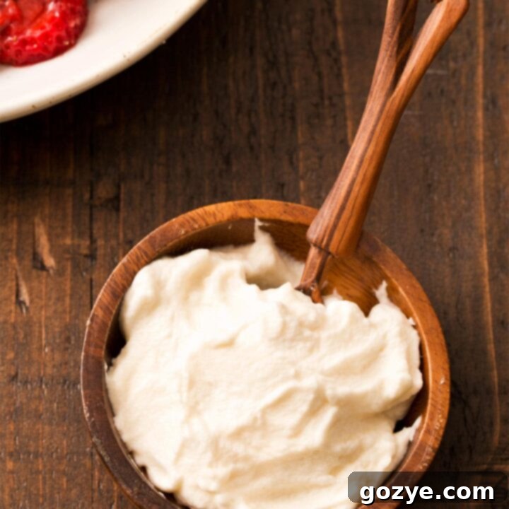 Honey whipped cream in small brown bowl