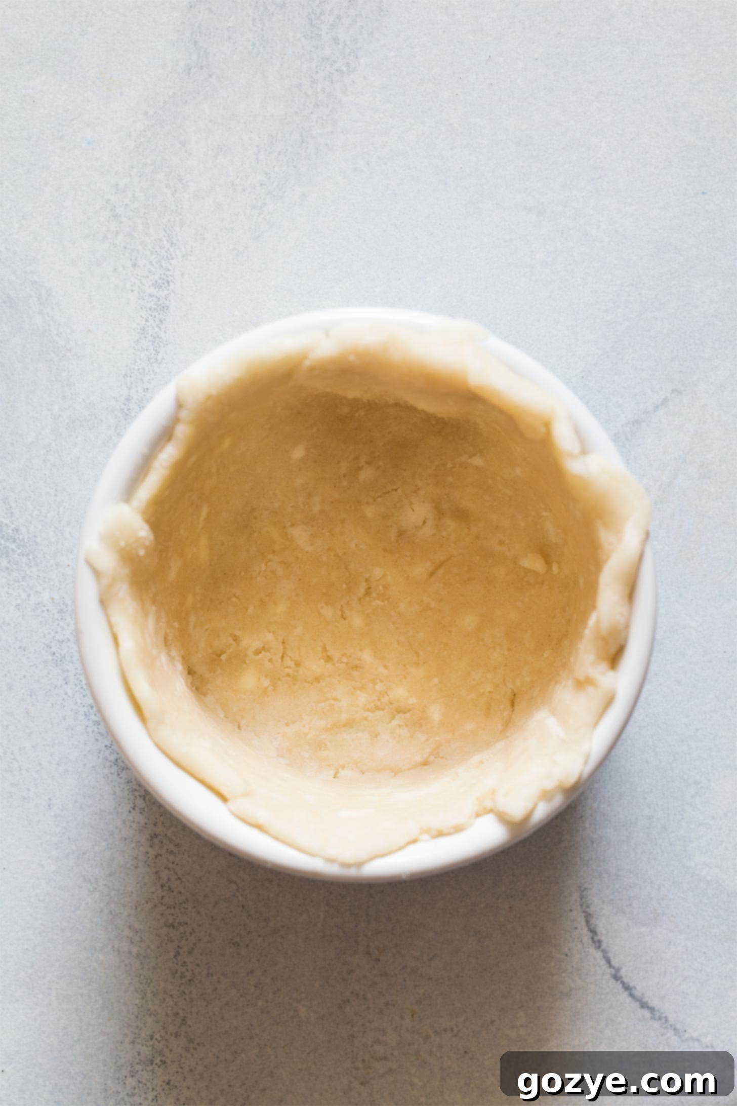 Adding pie dough to ramekin