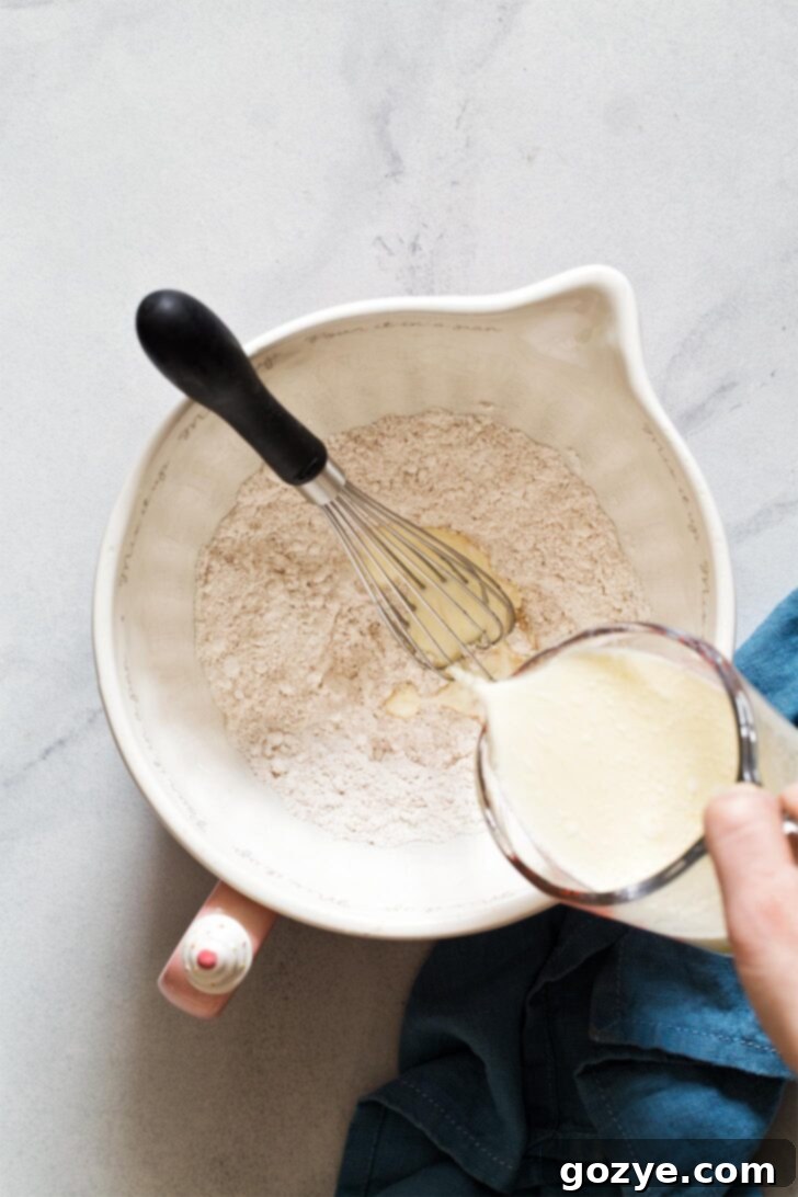 Adding wet ingredients to dry ingredients for making small batch pancakes