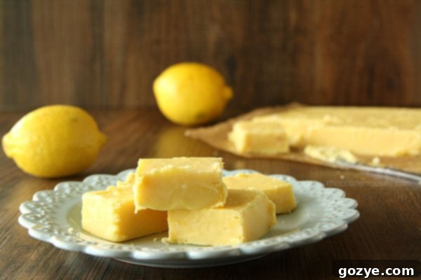 Creamy Lemon Fudge from www.chocolatemoosey.com Close-up of a perfectly cut square of creamy lemon fudge, showing its dense, smooth texture.