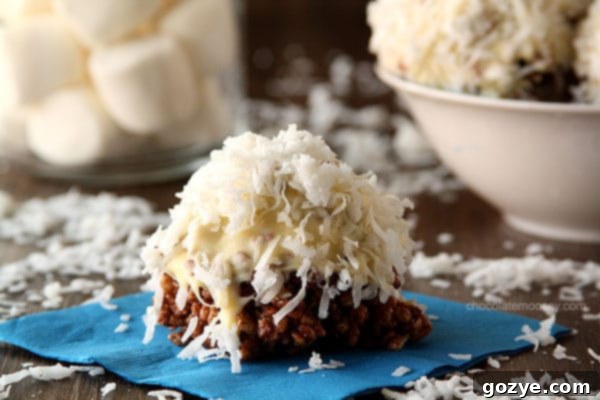 Giant Rice Crispy Treat Snowballs 5 A close-up of a plate piled high with chocolate coconut Rice Crispy Treat Snowballs, ready for tasting