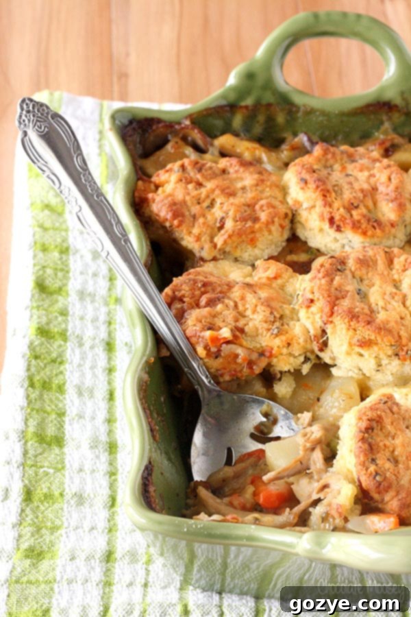 Chicken Pot Pie Casserole topped with homemade bacon cheddar biscuits