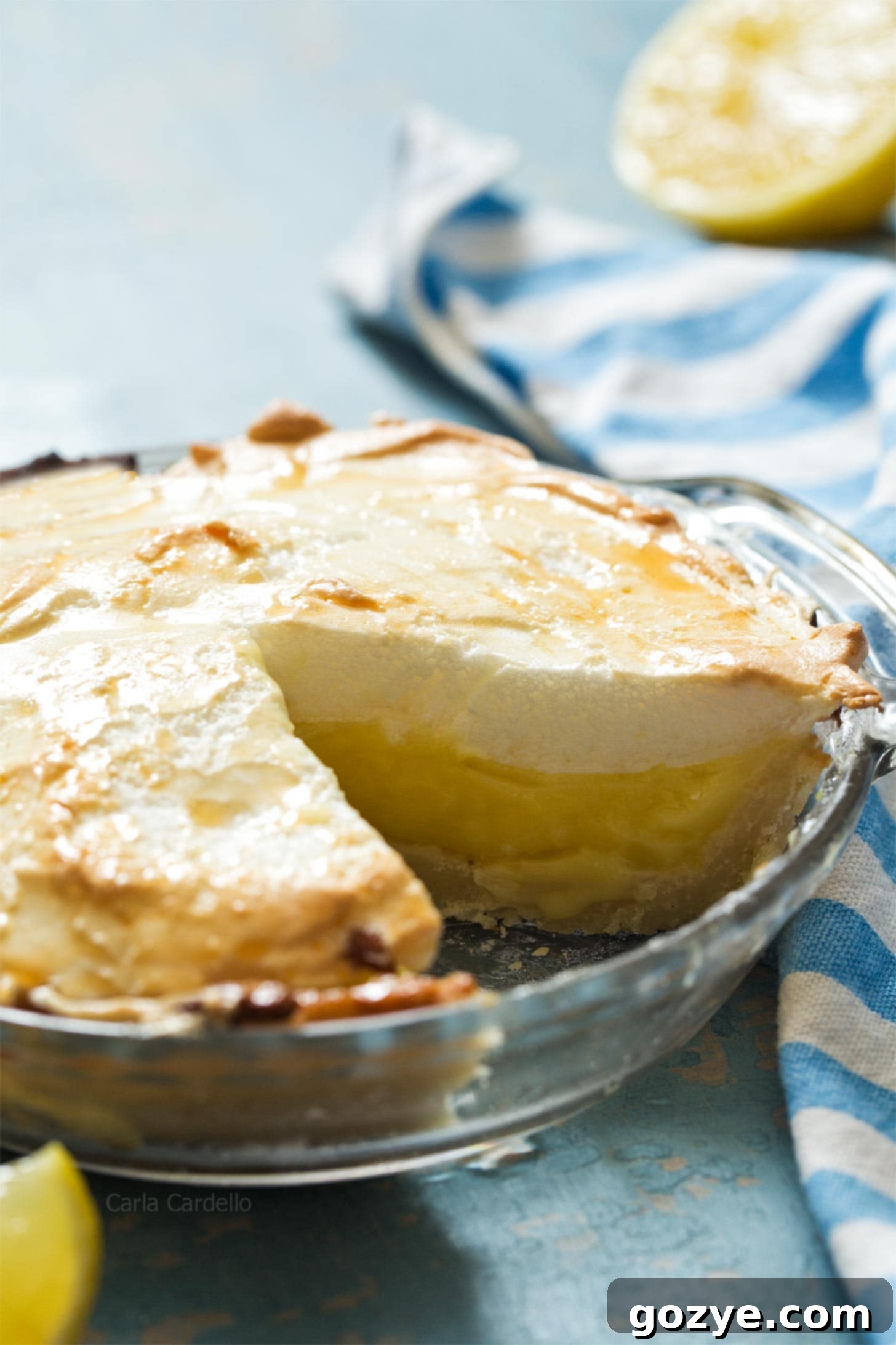 A perfectly cut slice of a 6-inch lemon meringue pie, showing the distinct layers.