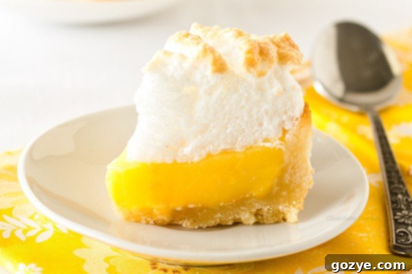 Close-up of a mini lemon meringue pie slice, highlighting the creamy lemon filling.