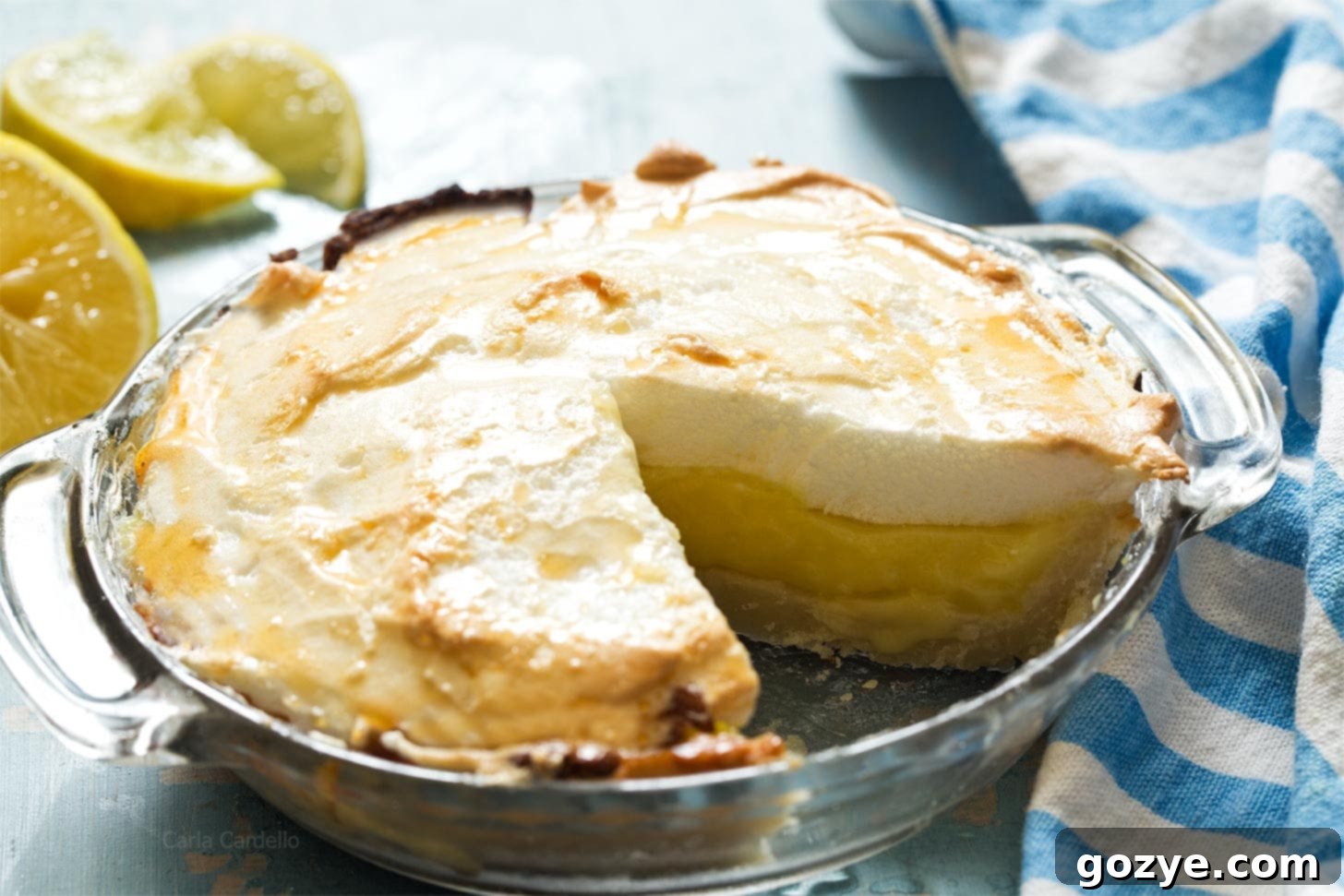 A large slice of a 6-inch lemon meringue pie, showing the vibrant yellow filling and fluffy meringue.