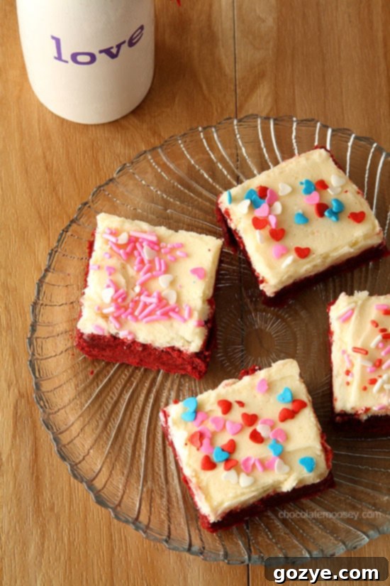 Red Velvet Sugar Cookie Bars with a sweet cream cheese frosting and festive sprinkles