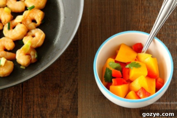 Ingredients for Mango Salsa including diced mango, red bell pepper, and fresh cilantro, ready for mixing.