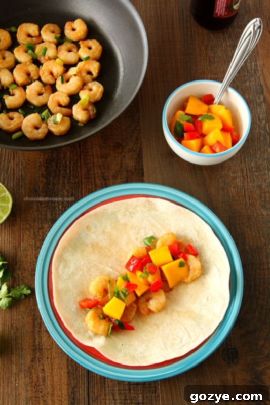 Plated Asian Shrimp Tacos with Mango Salsa, garnished with fresh cilantro, ready to be enjoyed.