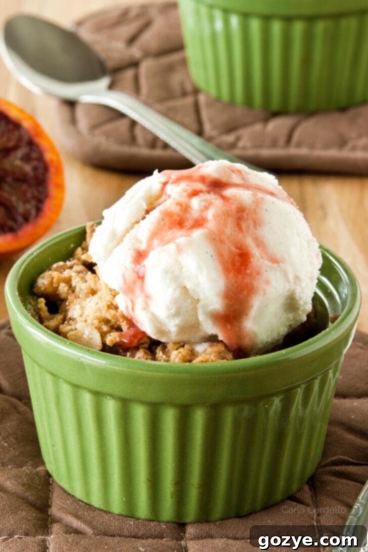 Blood Orange Pear Crisp 2 Pear Crisp with vanilla ice cream and blood orange sauce on top, presented in a small ramekin