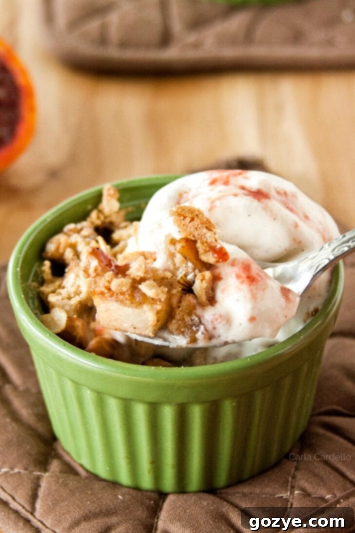 Spoon taking a bite of pear crisp