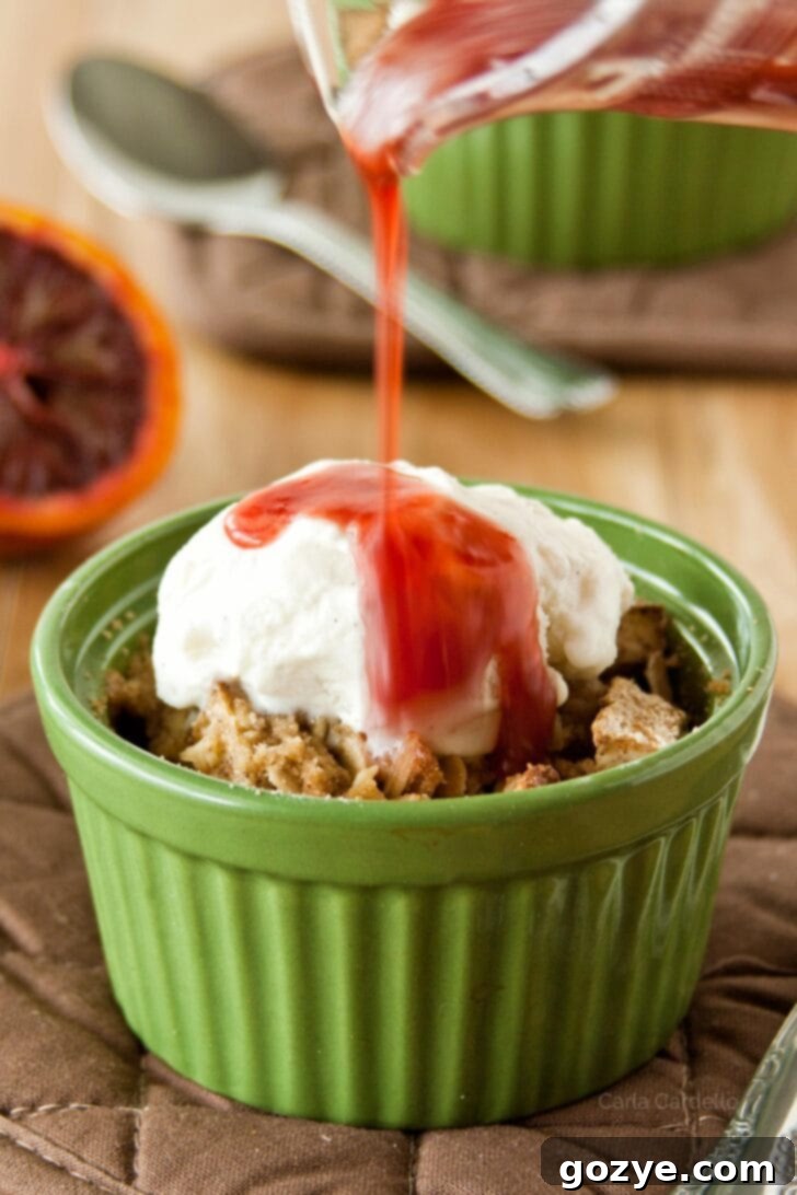 Blood Orange Pear Crisp 5 Pouring blood orange sauce on top of a baked pear crisp, highlighting the vibrant color