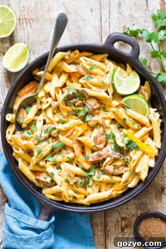 Close-up of creamy Chicken Fajita Pasta, showcasing perfectly cooked chicken, vibrant peppers, and onions