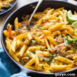 Close up of Creamy Chicken Fajita Pasta in a bowl, showcasing the rich sauce and ingredients
