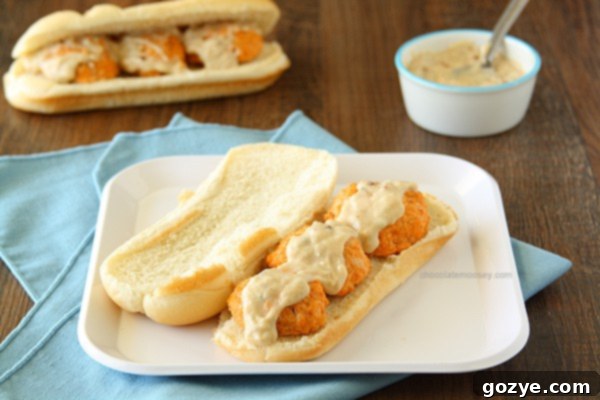 Delicious Buffalo Chicken Meatball Subs ready to be served, topped with sauce.