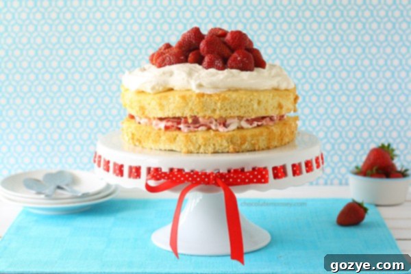 Beautifully decorated Layered Strawberry Shortcake on a cake stand