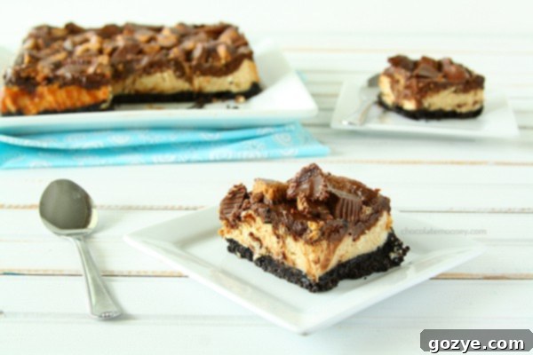Chocolate Peanut Butter Cup Cheesecake Squares on a serving tray | www.chocolatemoosey.com