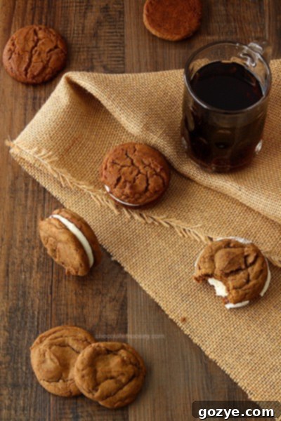 A Root Beer Float Sandwich Cookie held up, showing the thick vanilla cream filling