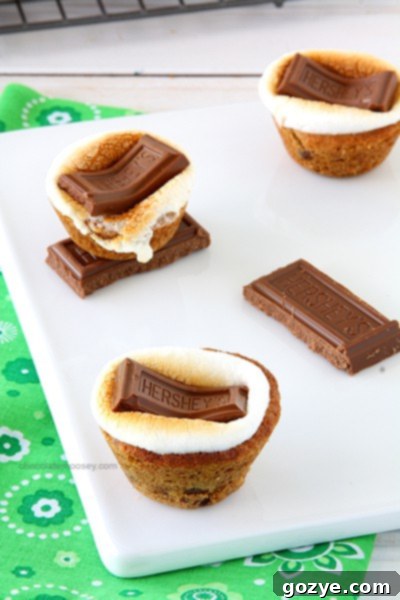 Three S'mores Chocolate Chip Cookie Cups stacked on a plate