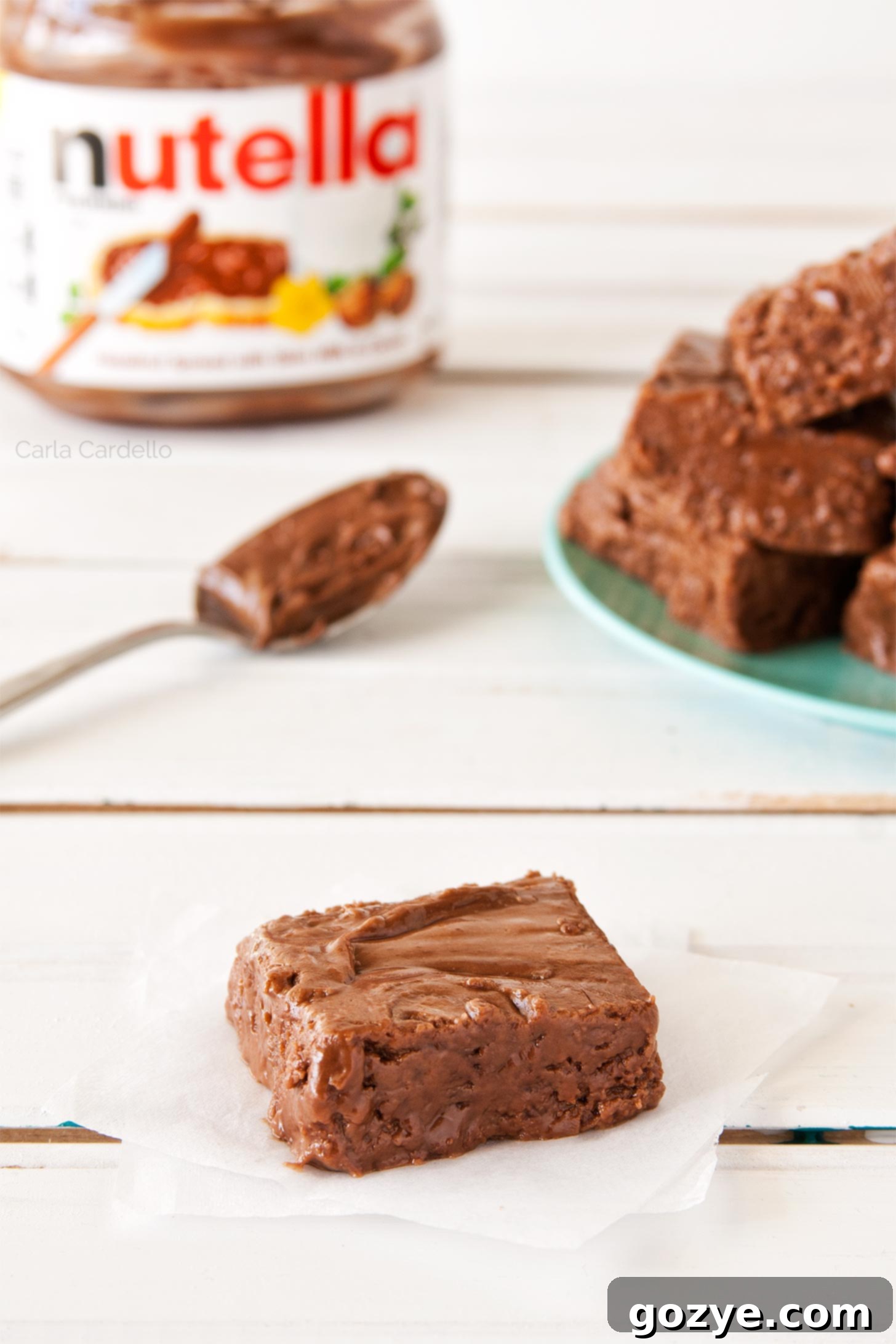 Decadent Nutella Fudge 3 Multiple squares of Nutella Fudge arranged neatly on a serving platter, showcasing their appealing texture and rich color.