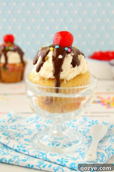 Funfetti Ice Cream Sundae Cupcakes | A vibrant Funfetti cupcake topped with vanilla frosting, chocolate magic shell, and a cherry.