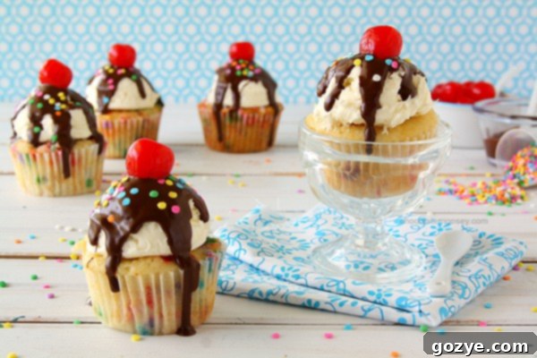 Funfetti Ice Cream Sundae Cupcakes | Four colorful Funfetti Ice Cream Sundae Cupcakes with chocolate shell and cherries.