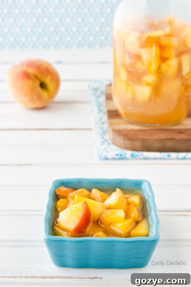 Close-up of freshly made peach pie filling in a rustic blue bowl, ready for use