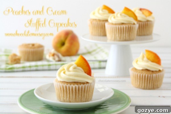 Peaches and Cream Stuffed Cupcakes with cream cheese frosting, ready to be enjoyed