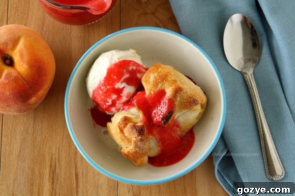 Close-up of a Peach Dumpling with raspberry sauce, showcasing the flaky crust