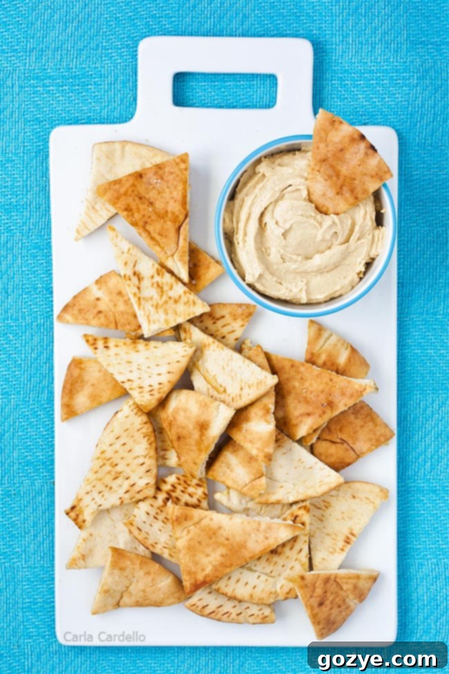 Homemade pita chips with hummus on serving platter