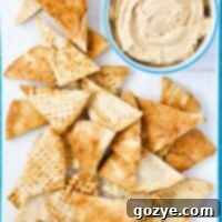 Close up of homemade pita chips on white serving platter