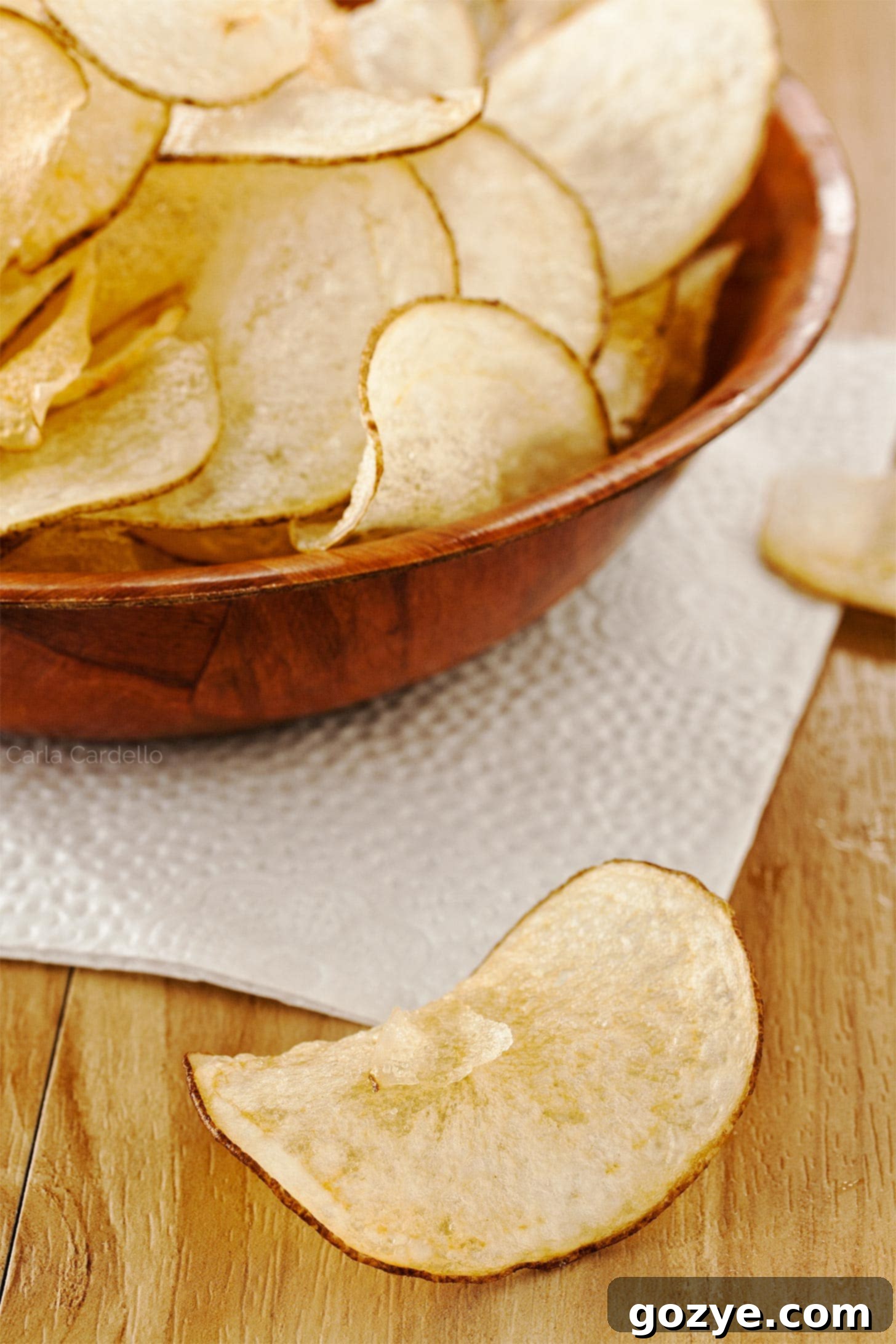 Homemade Zesty Salt and Vinegar Chips 3 Single salt and vinegar chip next to brown bowl of chips