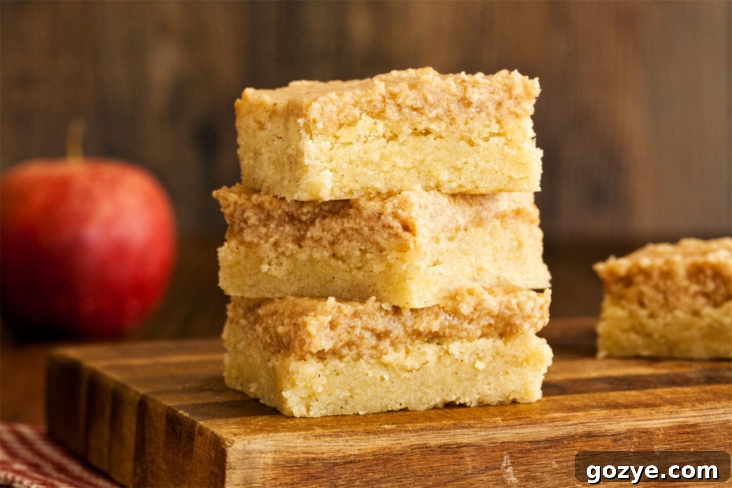 Close up of Snickerdoodle bars without cream of tartar, showing the soft, golden interior and the glistening cinnamon sugar topping