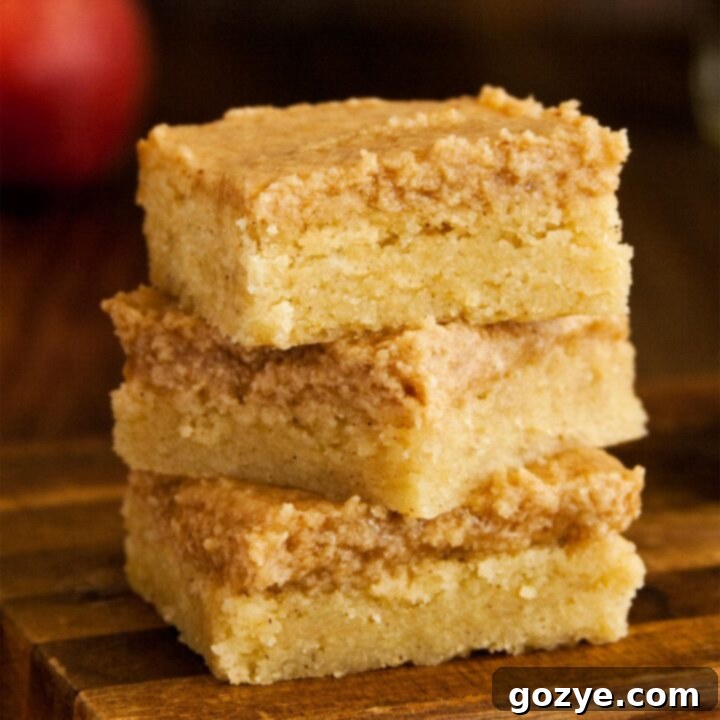 Close up of snickerdoodle cookie bars stacked on a white plate
