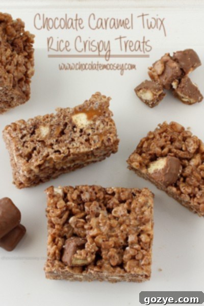 Twix Caramel Chocolate Crispy Bars 2 Irresistible Chocolate Caramel Twix Rice Crispy Treats on a cutting board, ready to be served.