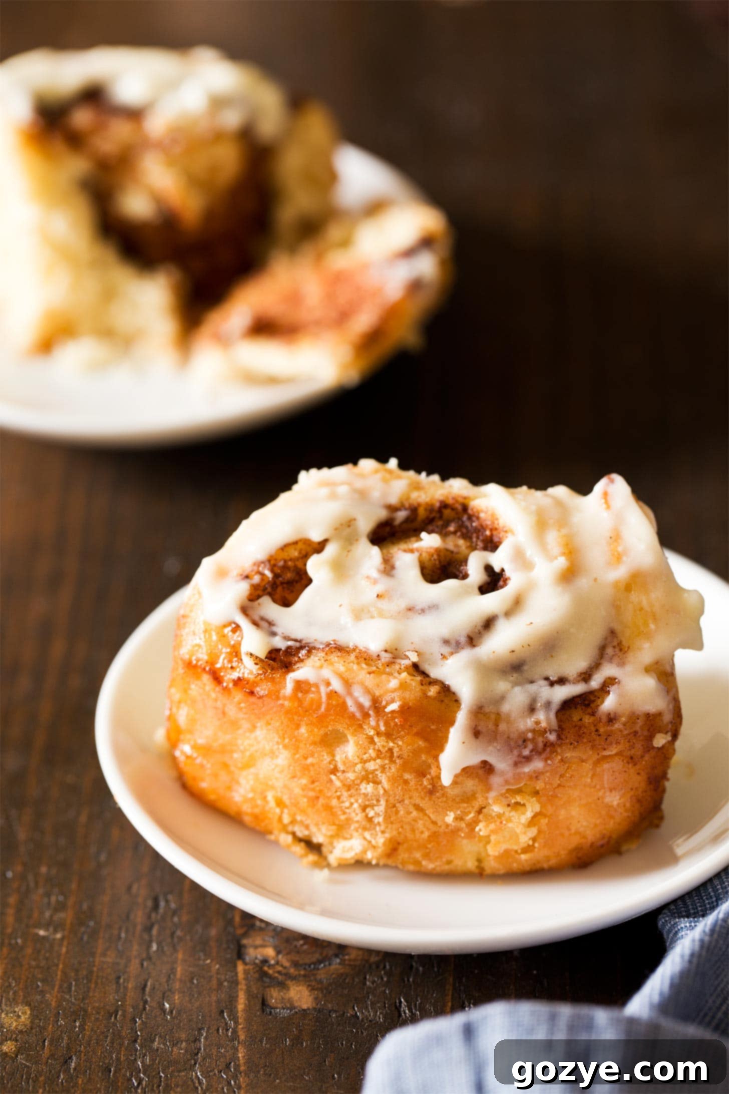 Quick & Cozy Cinnamon Rolls 5 Overnight cinnamon rolls on white plates