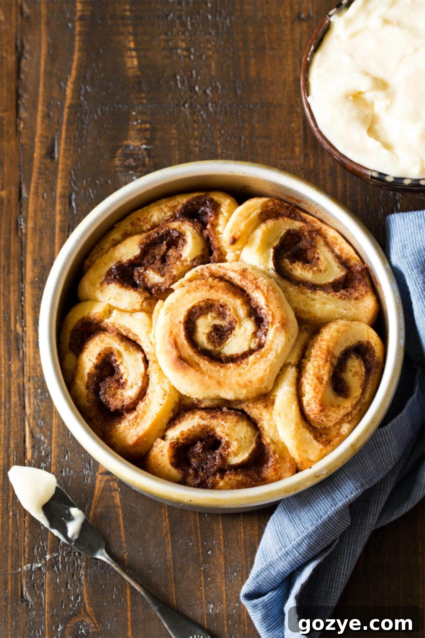Quick & Cozy Cinnamon Rolls 9 Getting ready to frost cinnamon rolls from scratch